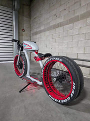 Custom retro electric cruiser in silver and red, rear three-quarter view