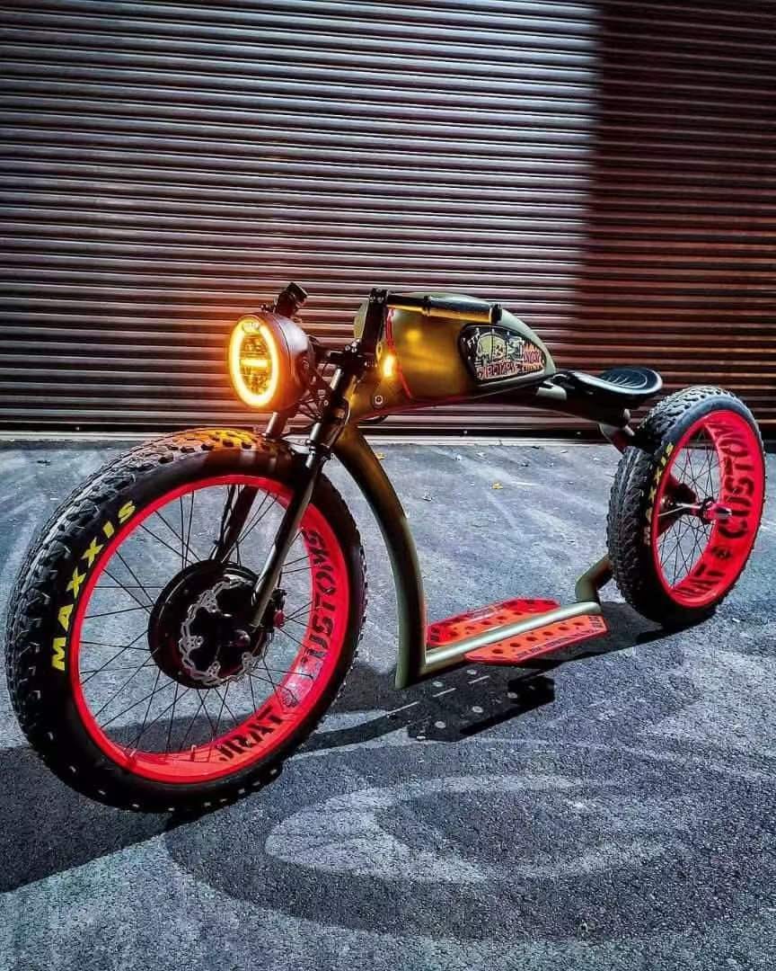 Custom retro electric cruiser in olive and red, illuminated front view